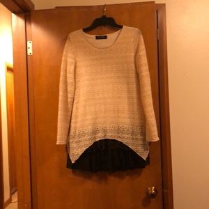 A tunic with ruffles at the bottom